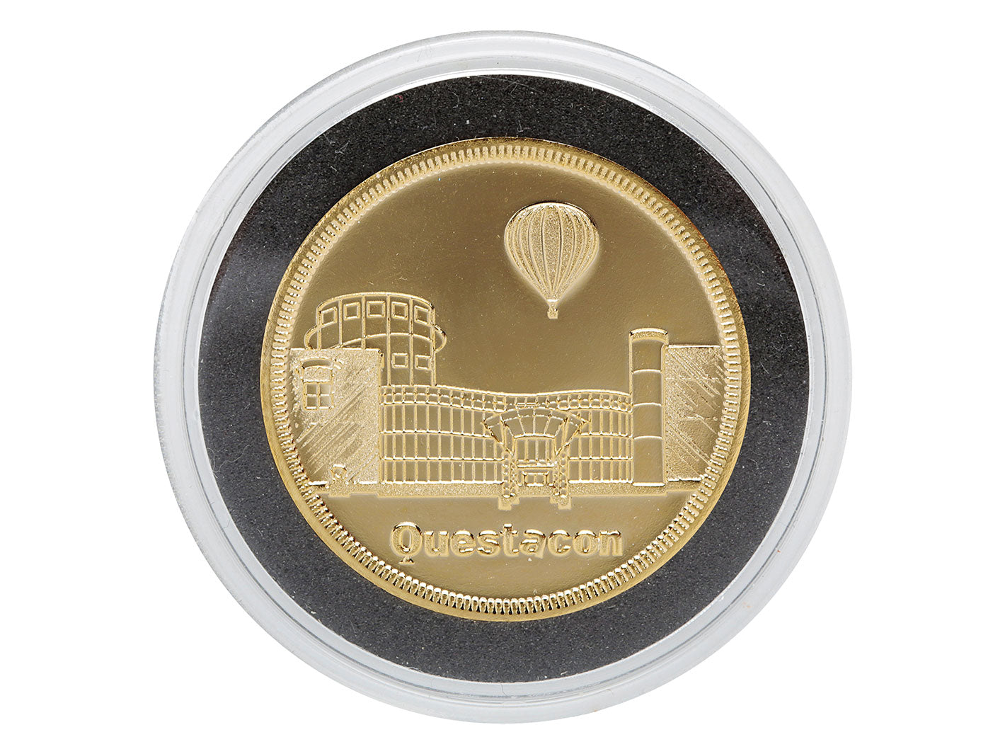A gold-coloured coin with an image of a hot air balloon and a building, with the brand 'Questacon' visible.