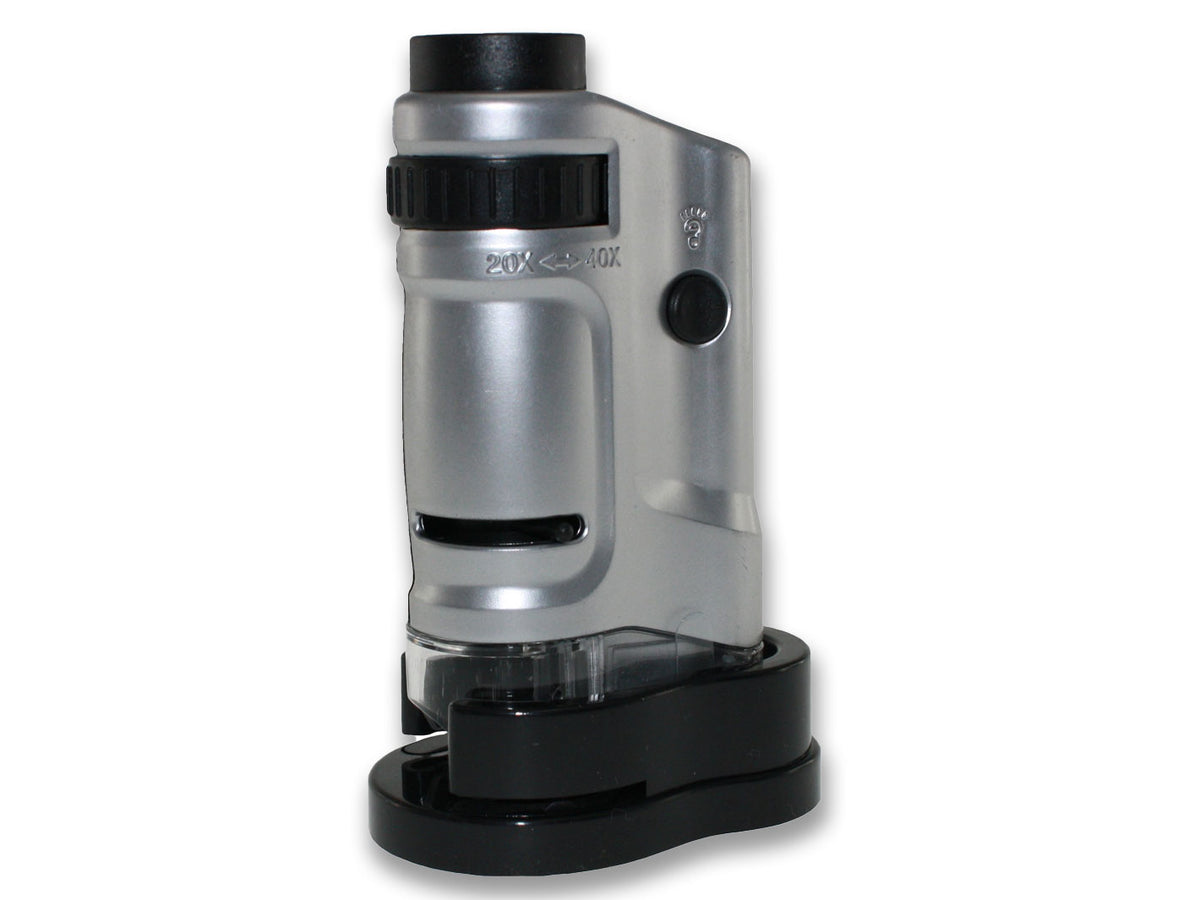A silver pocket microscope with a black base, featuring a zoom eyepiece and LED lamp.